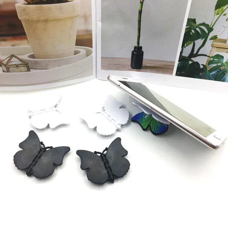 Color: black - 2pcs 360 Degree Phone Ring Stand Holder Butterfly Bling Glitter Universal Butterfly Wing holder finger ring holder