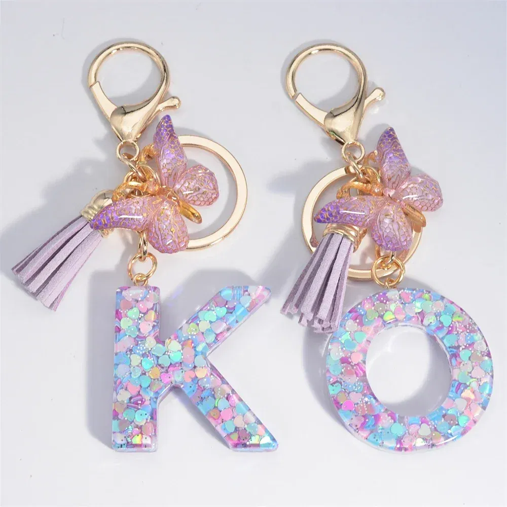 Color: Silver - Fashion Tassel Butterfly 26Letter Keychain Colorful Love Heart Filled Resin Alphabet Keyring Women Girls Car Bag Phone Pendant